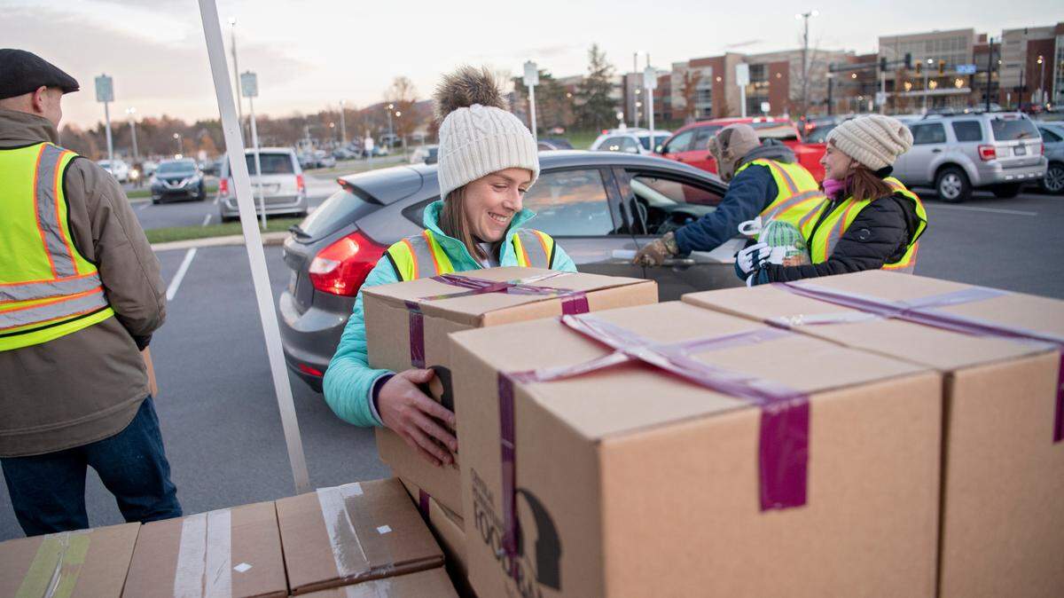 Tara Duff helps distribute food for a Thanksgiving meal to Centre County residents through the State College and Central Pennsylvania food banks on Tuesday, Nov. 16, 2021.