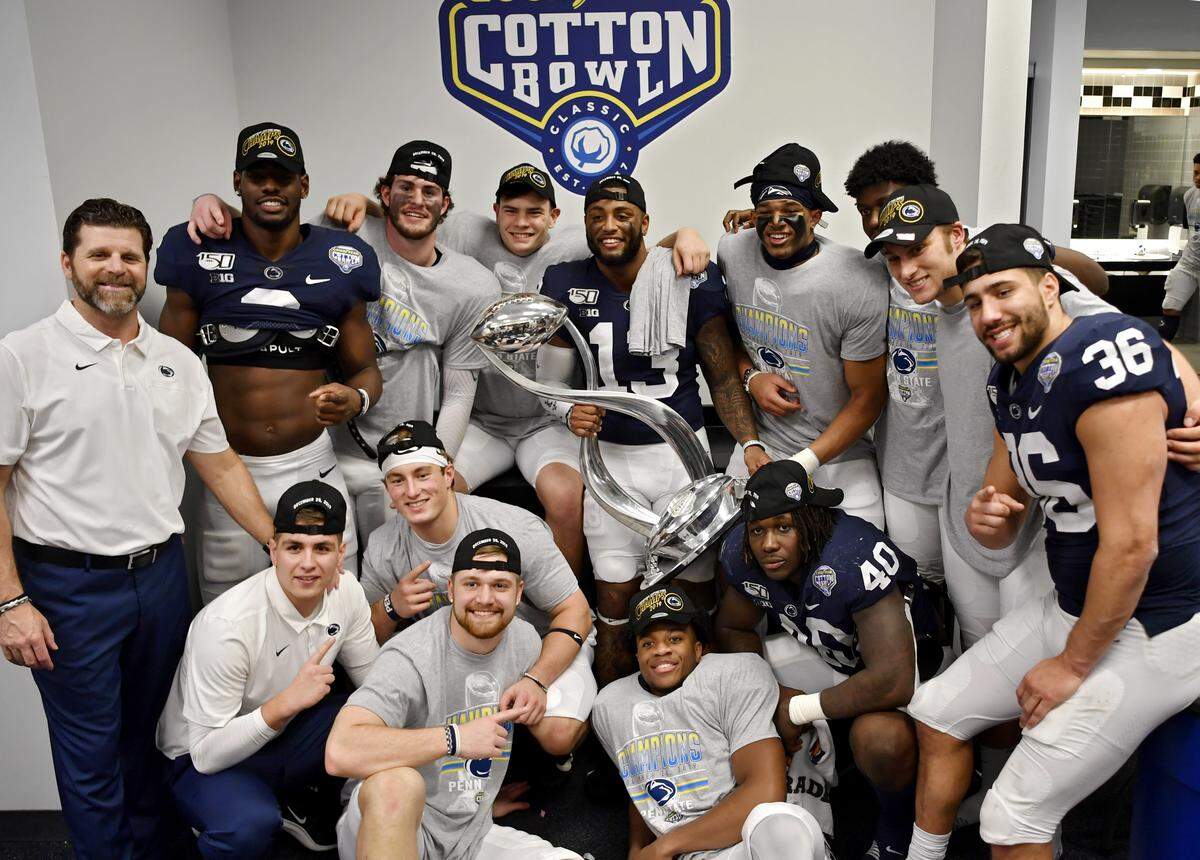 Members of the Penn State defense pose together with the Cotton Bowl trophy after the win over Memphis in the 84th Cotton Bowl at AT&T Stadium in Arlington, TX on Saturday, Dec. 28, 2019.