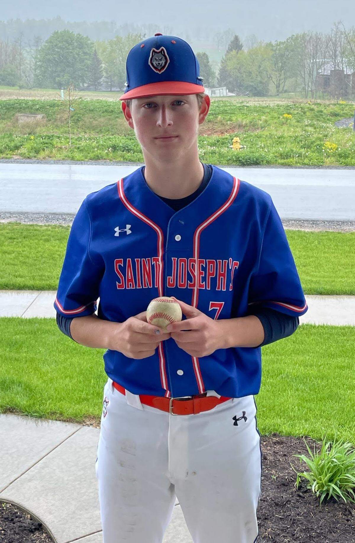 Saint Joseph’s junior Evan Roach holds the ball from his no-hitter against Neumann. It was the first no-hitter in program history.