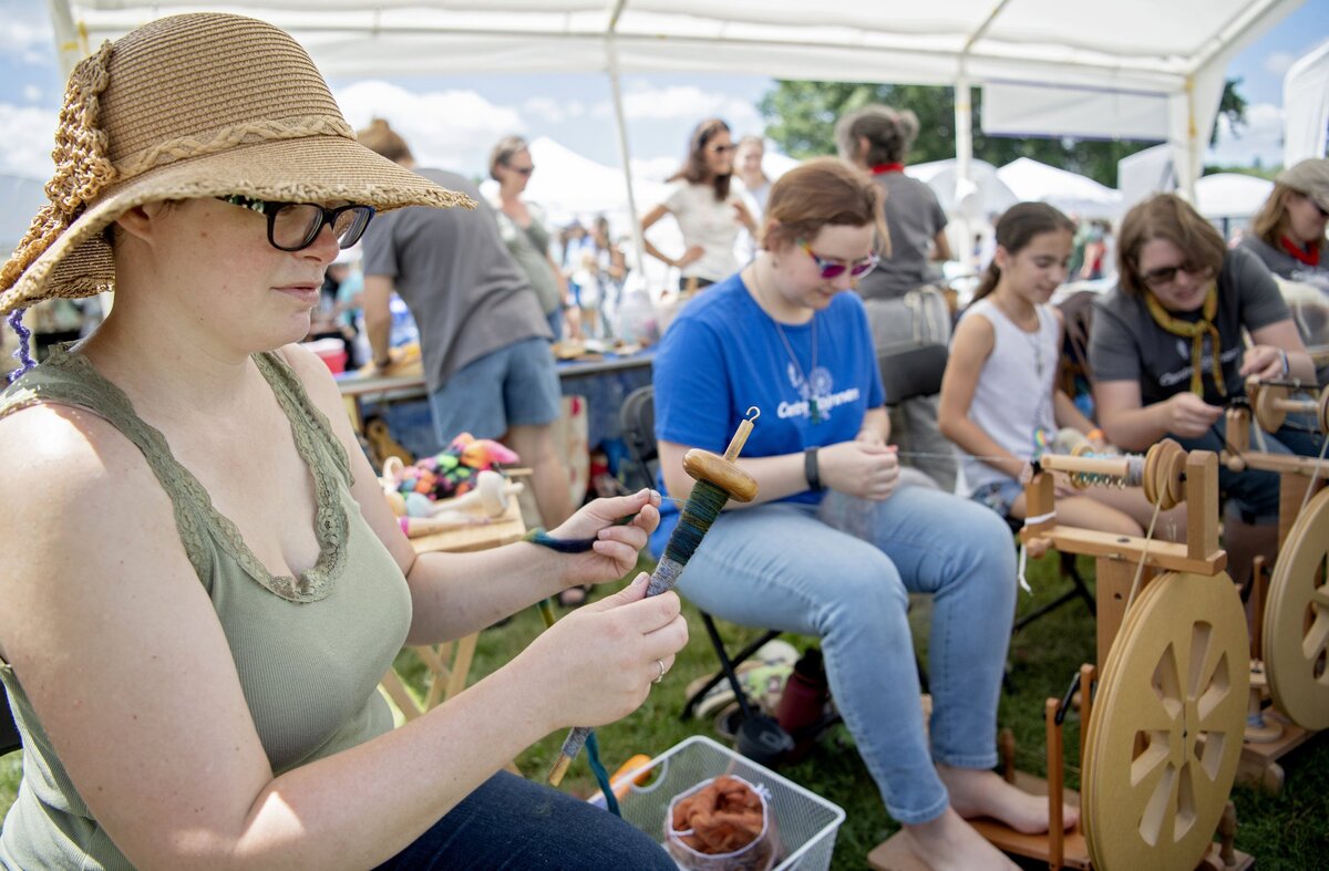 Hannah Black uses a drop spindle to spin yarn alongside the Centre Spinners at the People’s Choice Festival of Pennsylvania Arts & Crafts at the Pennsylvania Military Museum in Boalsburg on Friday, July 12, 2019.