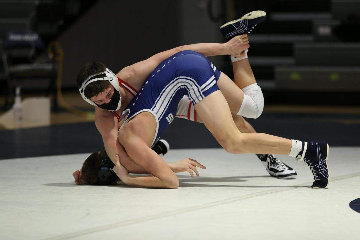 Bellefonte’s Jude Swisher looks to finish off a takedown of Penns Valley’s Ty Watson during their 132-pound bout on Thursday. Swisher beat Watson 16-4 as the Red Raiders won 43-15.