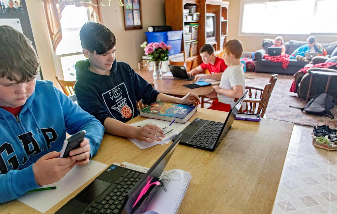 The Madisonburg family of Gabe Hettinger, Matt Ruoff, Gavin Hettinger, Luke Ruoff, Katie Ruoff and Andrew Ruoff all try to complete school work on Thursday, May 14, 2020.
