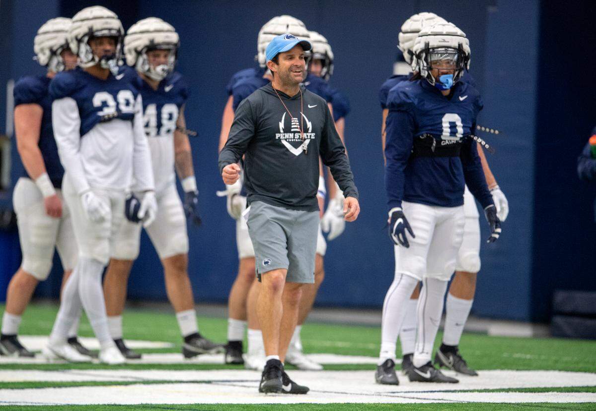 Penn State defensive coordinator Manny Diaz talks to his players as they run a drill during spring practice on Wednesday, March 30, 2022.