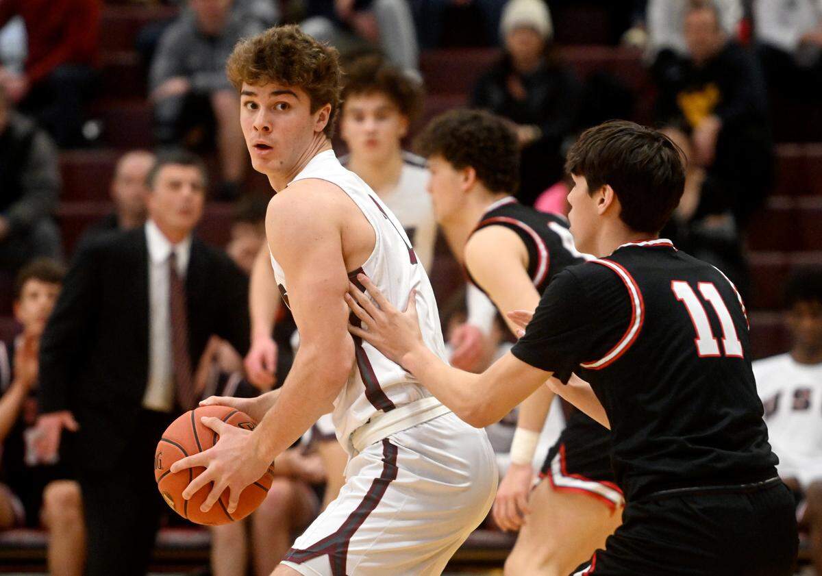 State College’s Finn Furmanek dribbles around an Upper St. Clair defender during the PIAA first round game on Saturday, March 11, 2023. State College won, 72-42.