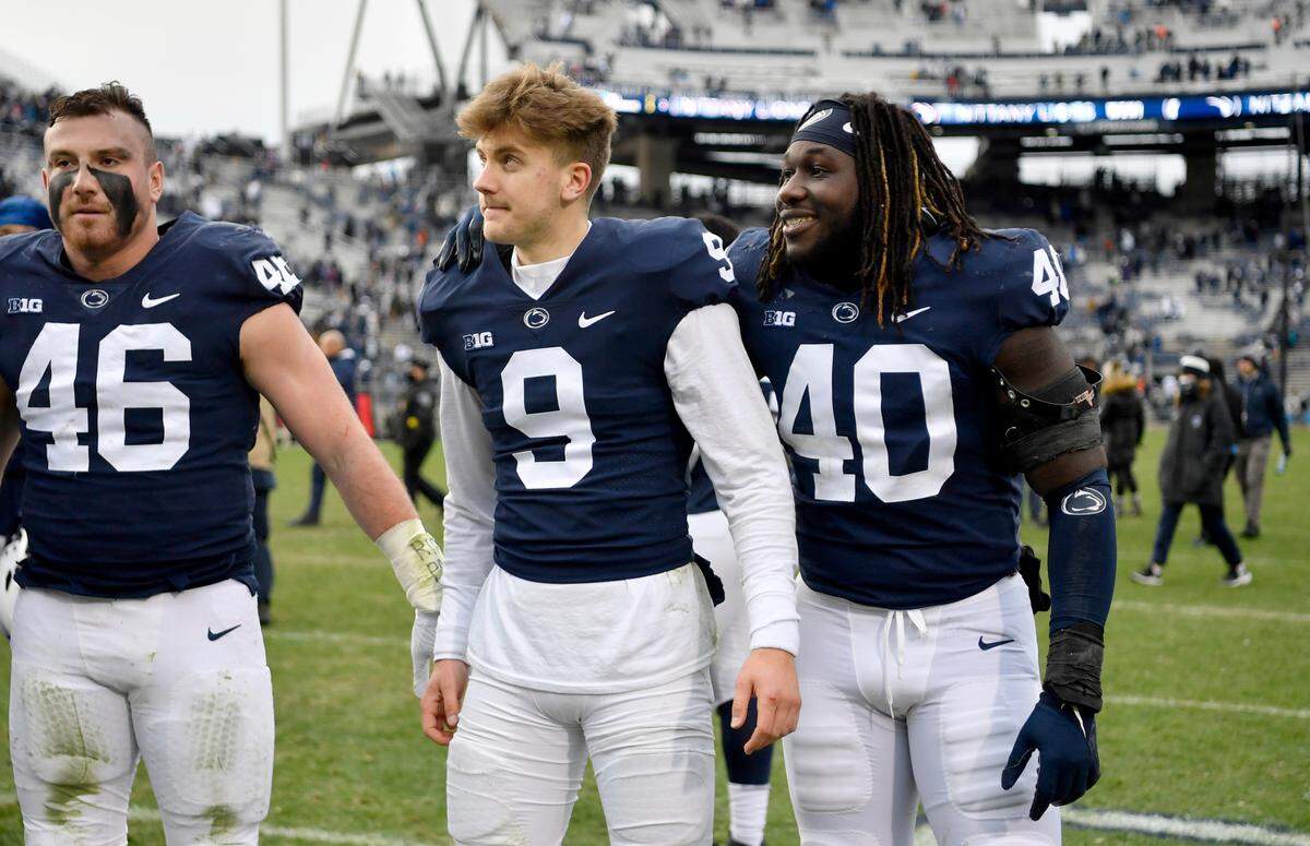 Penn State quarterback Christian Veilleux and linebacker Jesse Luketa stand together to sing the alma mater after the win over Rutgers on Saturday, Nov. 20, 2021. Veilleux and Luke are both from Canada.