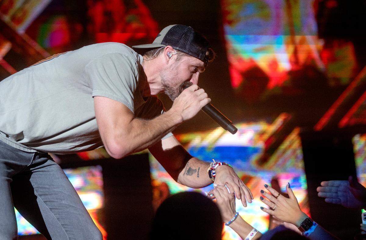 Walker Hayes reaches out to fans as he sings “Country Stuff” at the Bryce Jordan Center as part of the Duck Buck Tour on Thursday, April 27, 2023.