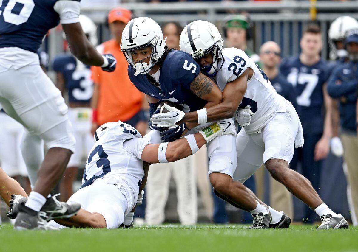 Wide receiver Omari Evans is stopped by cornerback Storm Duck during the Penn State Blue-White game on Saturday, April 15, 2023.