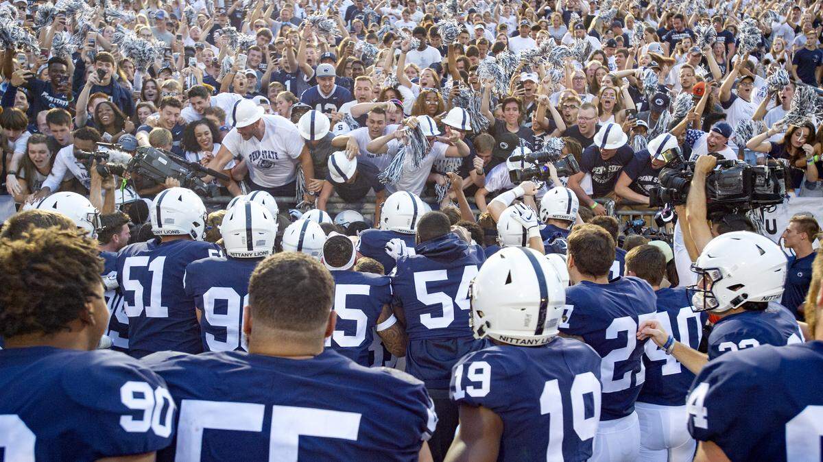 Penn State celebrates with Penn State cornerback Amani Oruwariye and the student sections after his interception to beat Appalachian State in overtime of for the Saturday, Sept. 1, 2018 game at Beaver Stadium. 
