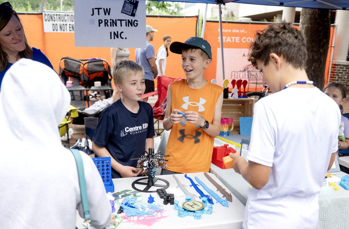 Friends Jake Haas and Tyler Aten talk to customers about their 3D printed items during the Children and Youth Day sidewalk sale at the Central Pennsylvania Festival of the Arts on Wednesday, July 8, 2026.