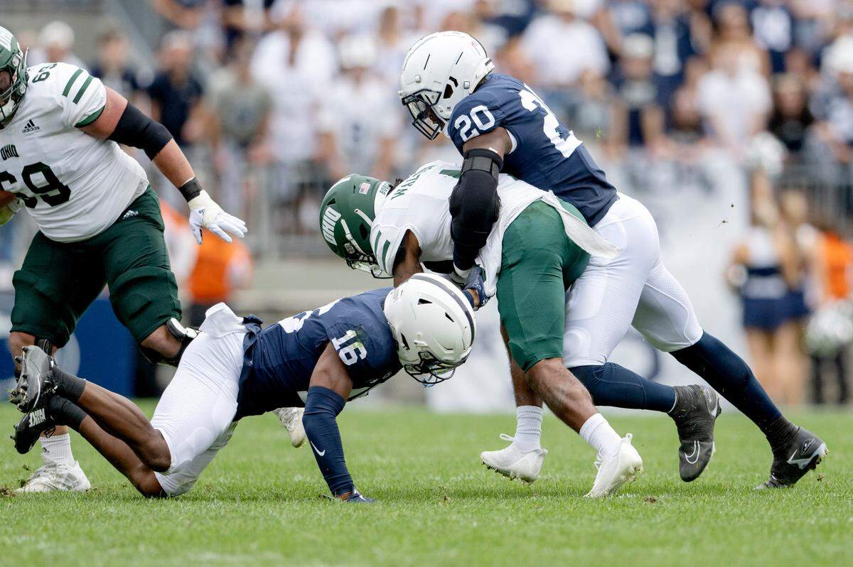 Penn State safety Ji’Ayir Brown and defensive end Adisa Isaac stop Ohio’s ball carrier Tyler Walton during the game on Saturday, Sept. 10, 2022.
