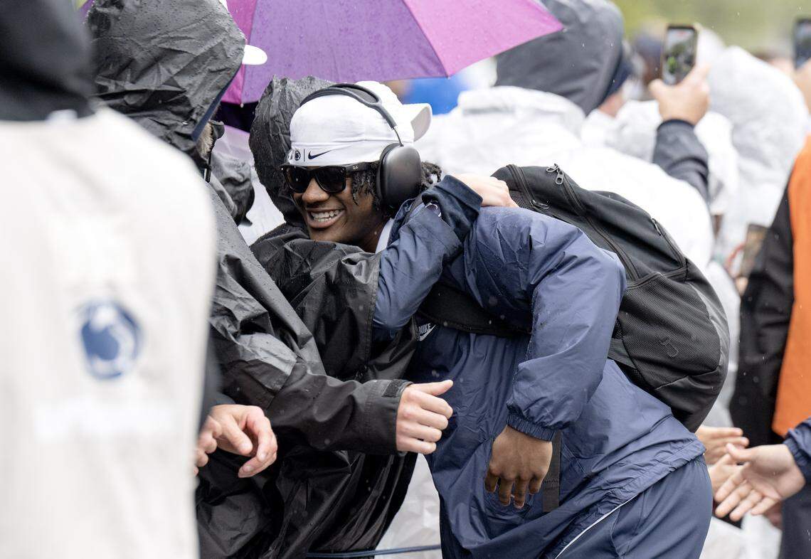 Players hug fans as they arrive at Beaver Stadium for the Blue-White Practice on Saturday, April 25, 2026.  