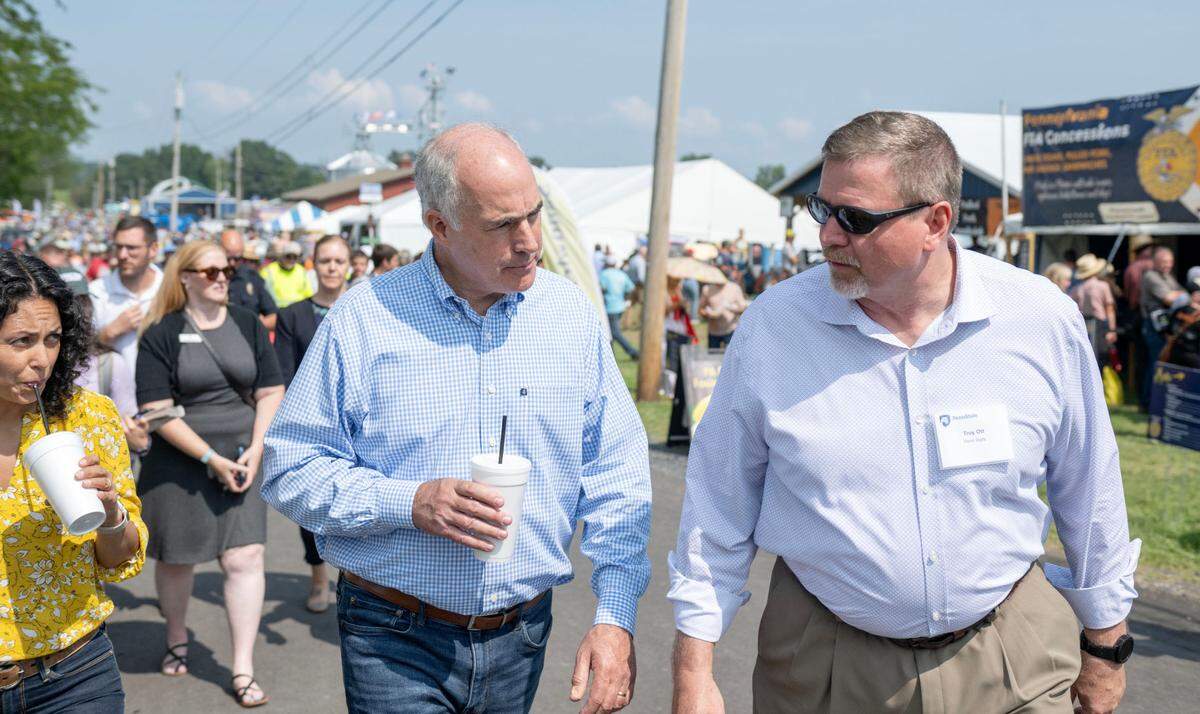 U.S. Sen. Bob Casey chats with Penn State College of Agricultural Sciences dean Troy Ott as they walk together at Penn State’s Ag Progress Days on Wednesday, Aug. 14, 2024.