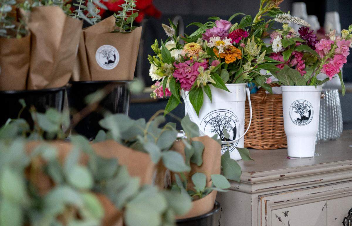 Eucalyptus and a bucket full of flowers from pick your own at Rooted Farmstead on Friday, Aug. 5, 2022.