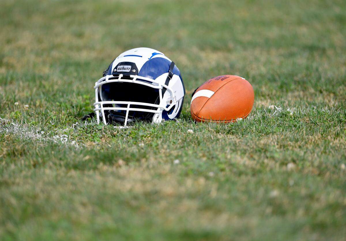 A Penns Valley football helmet and ball sit on the field during practice on Wednesday, Sept. 2, 2020.
