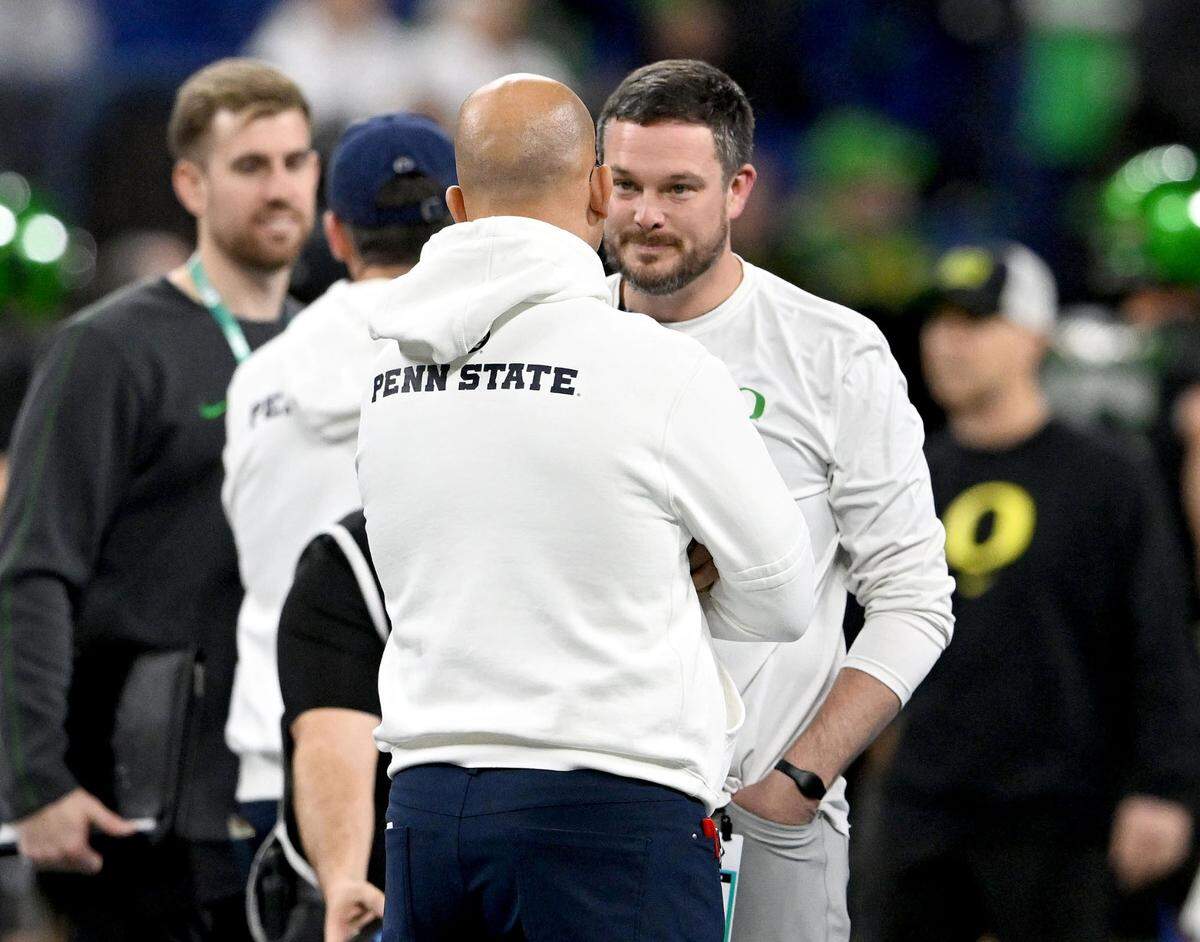 Penn State football coach James Franklin talks to Oregon football coach Dan Lanning before the Big Ten Championship game at Lucas Oil Stadium on Saturday, Dec. 7, 2024.