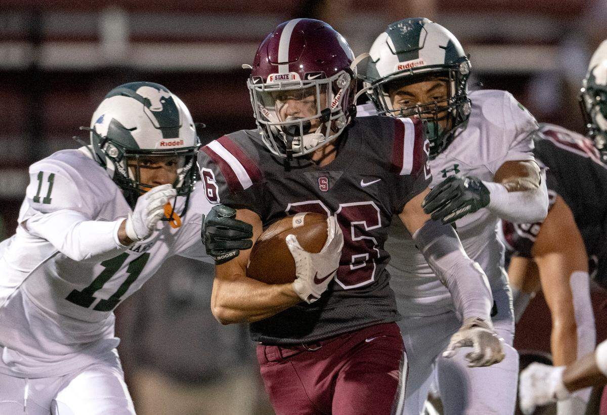 Central Dauphin defenders can’t stop State College’s Matt Wall as he runs with the ball during the game on Friday, Sept. 23, 2022 at Memorial Field.