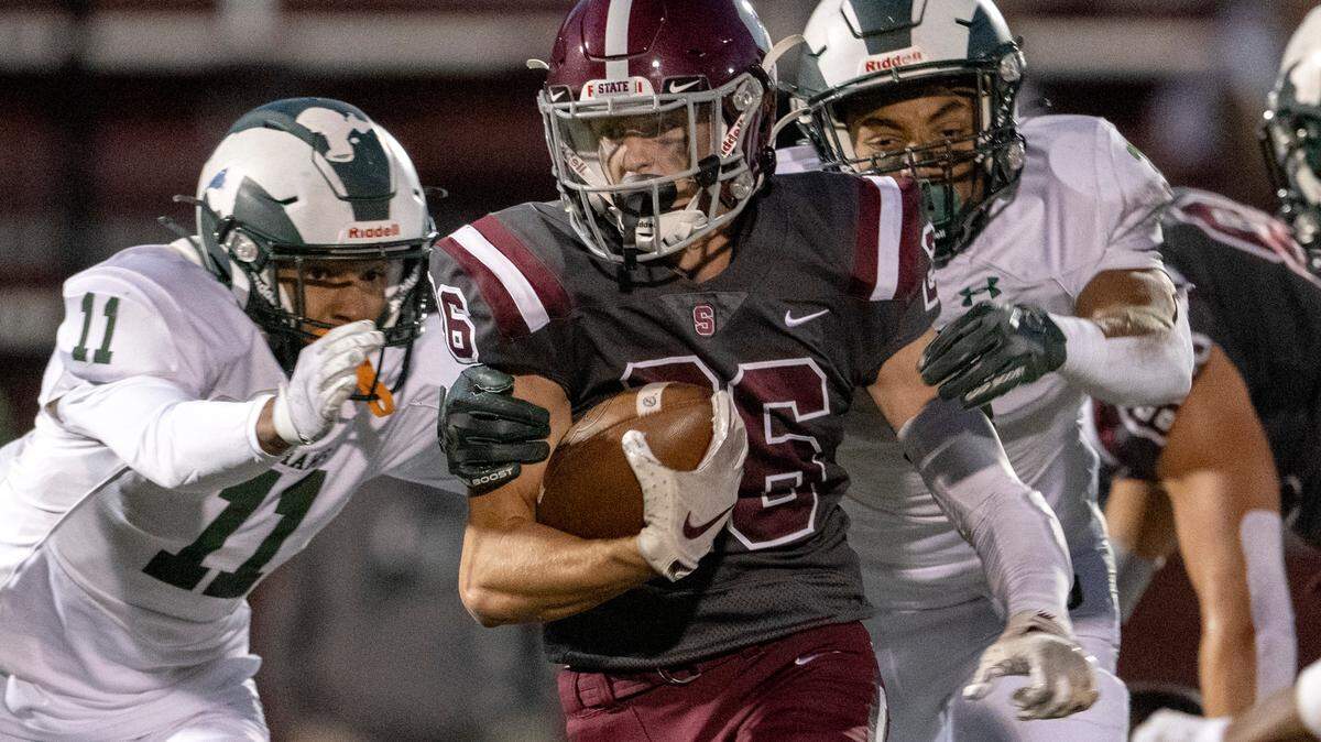 Central Dauphin defenders can’t stop State College’s Matt Wall as he runs with the ball during the game on Friday, Sept. 23, 2022 at Memorial Field.