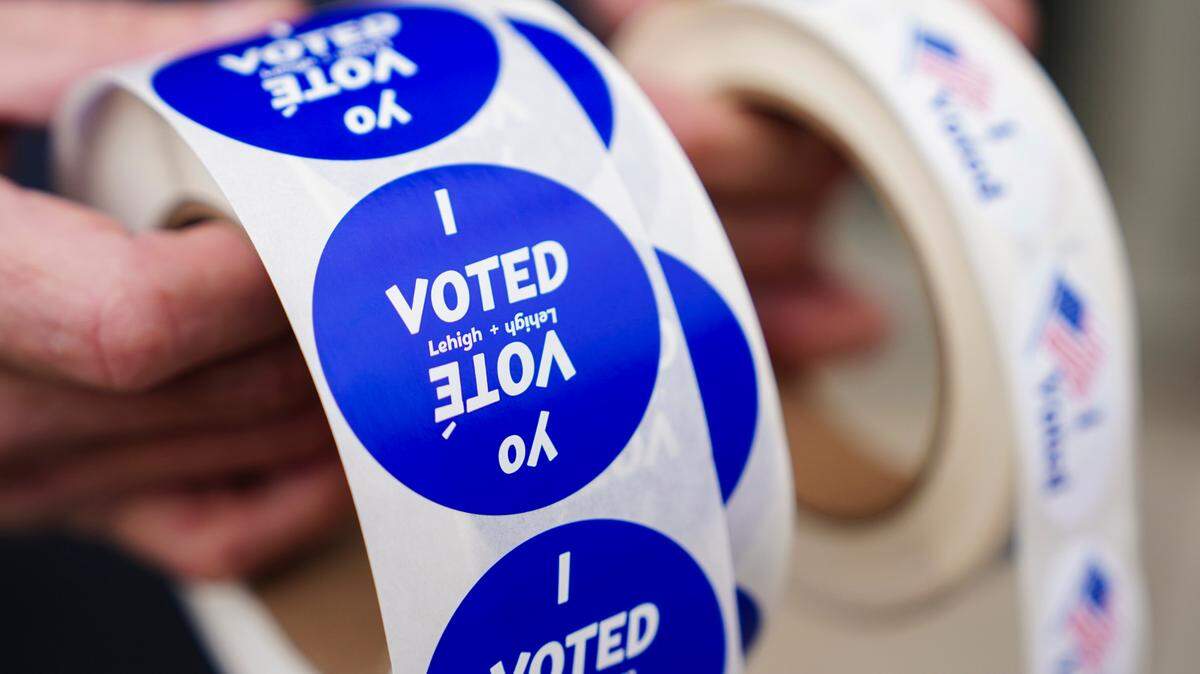 A poll worker holds voting stickers for community members Nov. 7, 2023, at Central Elementary School in Allentown, Lehigh County, Pennsylvania.