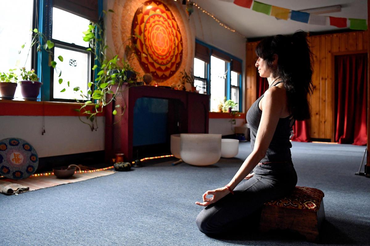Erica Kaufman of Lila Yoga sits in meditation at the studio on Thursday, Feb. 27, 2020.