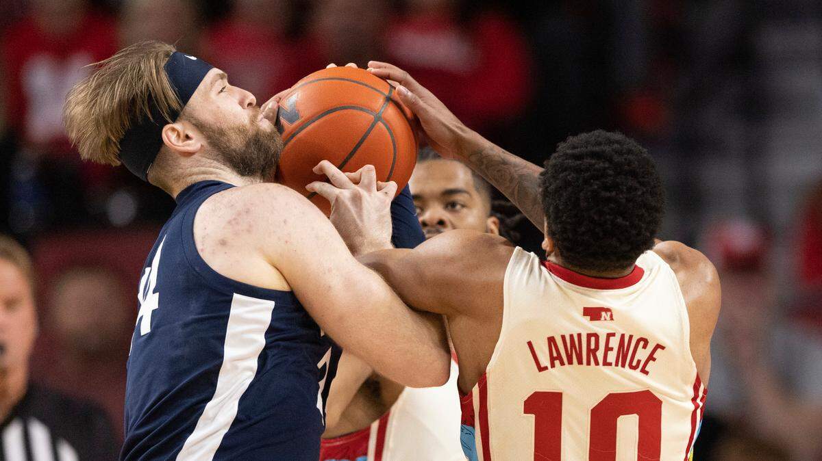 Penn State’s Michael Henn, left, battles for possession against Nebraska’s Jamarques Lawrence during the first half of an NCAA college basketball game, Sunday, Feb. 5, 2023, in Lincoln, Neb.