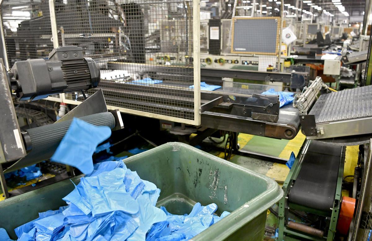 The cutouts from the handles for a plastic bag drop into a bin to be melted down and reused at the Hilex Poly facility in Milesburg on Wednesday, August 14, 2019.