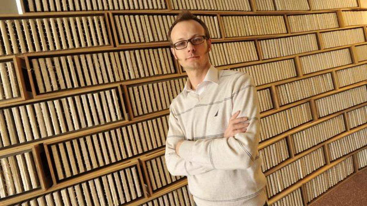 Will Snyder with the sculpture he made as a memorial to the 1994 Rwandan genocide on Monday, March 24, 2014. It's 800,000 pages in 2,500 books stored in 100 crates. This summer, the artwork will be installed and displayed at the United Nations building in New York.

