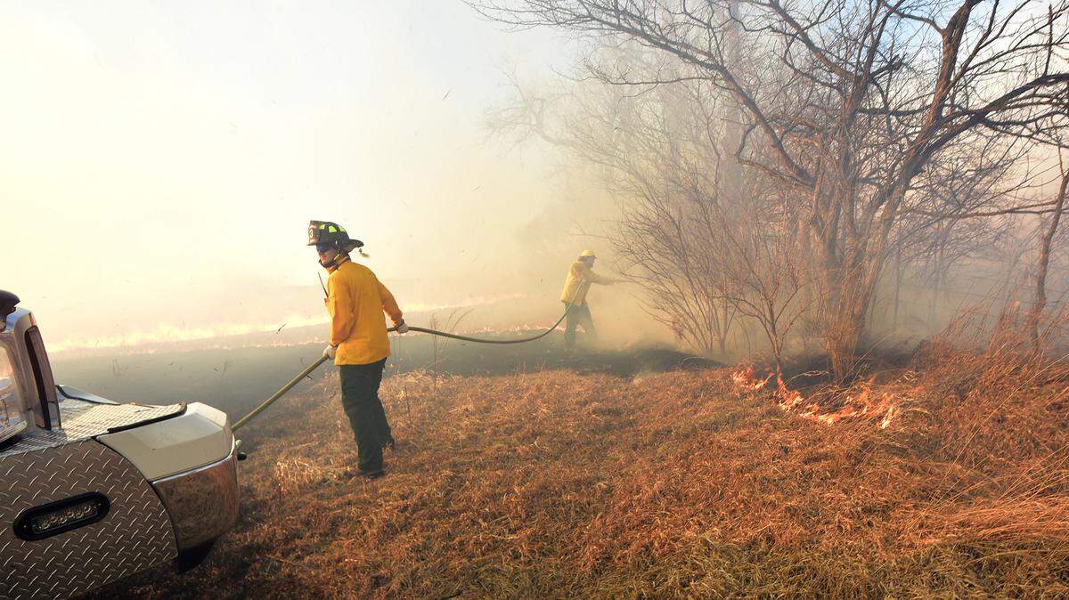 Two Boalsburg Fire Company firefighters put water on the fire line during a Sunday, Feb. 26, 2023 wildfire in Potter Township.