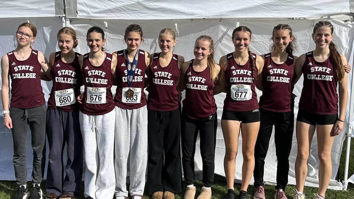 From left, State College girls cross country’s Kaitlyn Baylis, Silvie Hutchinson, Ainsley Barabas, Evie Younkin, Carolyn Frank, Anne Horgas, Julia Bigger, Autumn Swisher and Lacey Sheaffer pose Saturday, Nov. 1, 2025 with medals from the PIAA cross country championships.