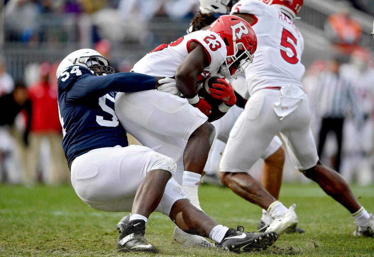 Penn State defensive tackle Derrick Tangelo pulls down Rutgers running back Kyle Monangai during the game on Saturday, Nov. 20, 2021.