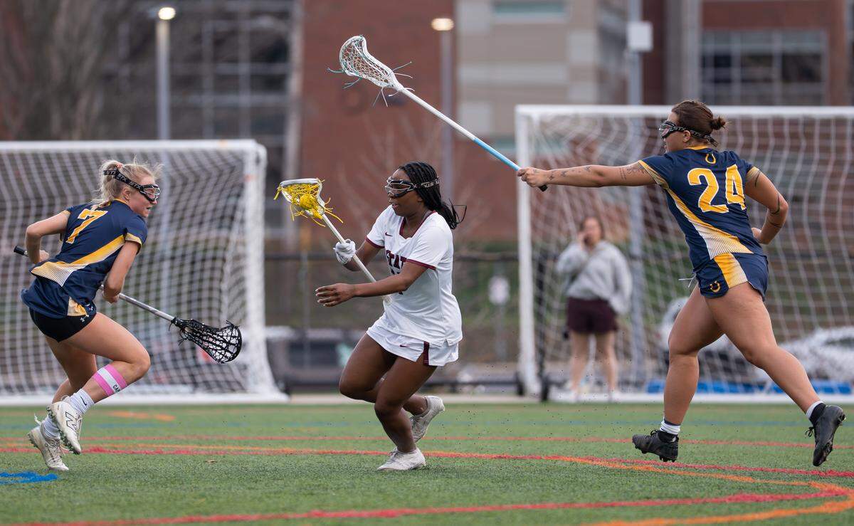State College’s McKenna Whitehurst (13) evades defenders during a lacrosse game against Cedar Cliff in State College, Pa., on Tuesday, March 31, 2026. The Little Lions lost to the Colts 10-7.