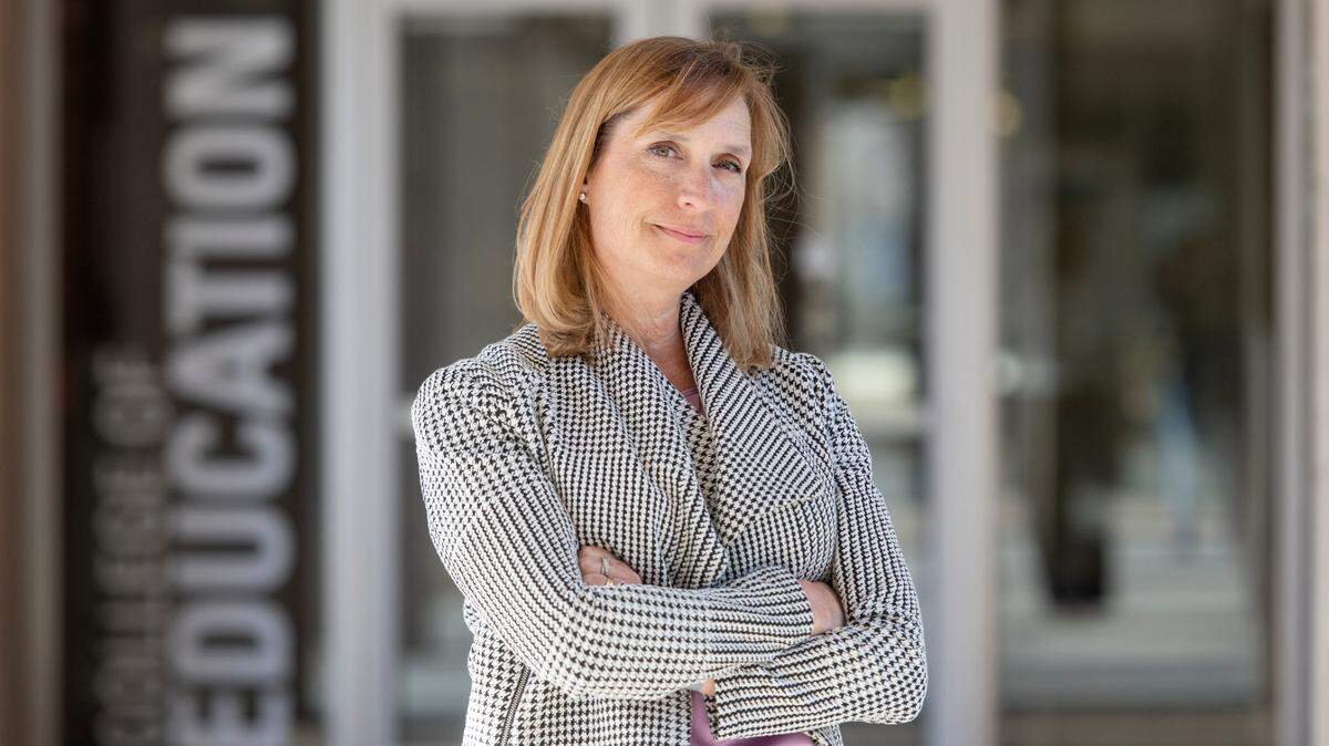 Dean of the College of Education Kimberly Lawless poses outside of the Chambers Building on the Penn State campus on Monday.
