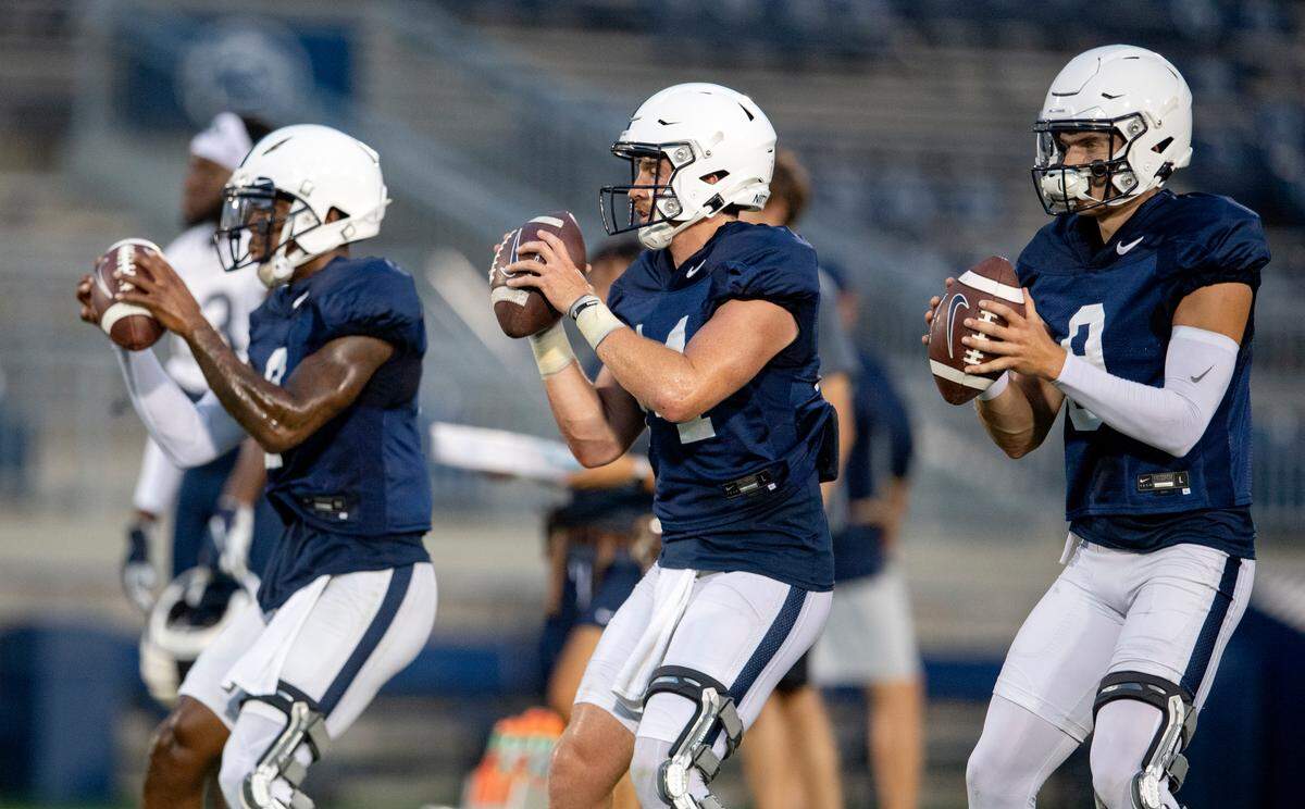 Penn State quarterbacks Ta’Quan Roberson, Sean Clifford and Christian Veilleux all drop back to make a pass during practice on Wednesday, Aug. 25, 2021 in Beaver Stadium.