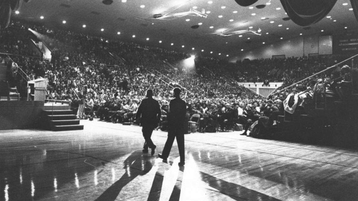 The Rev. Martin Luther King Jr. is escorted on stage to speak in a crowded Recreation Building on the University Park campus of Penn State in 1965. King’s assassination in 1968 had impact across the campus and nation.