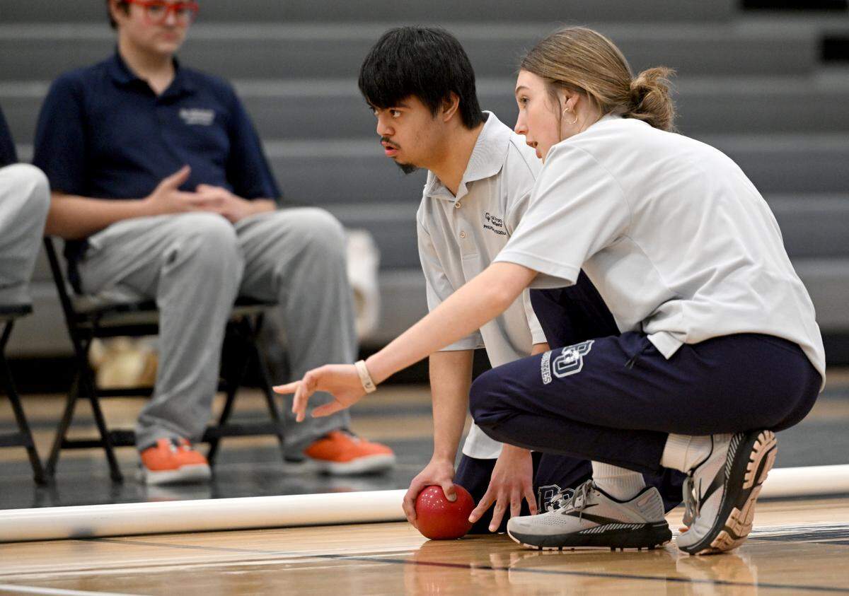 Philipsburg-Osceola’s Ezekiel Perez gets a tip from a teammate as he makes his roll during the unified bocce match against Penns Valley on Thursday, Jan. 30, 2025.