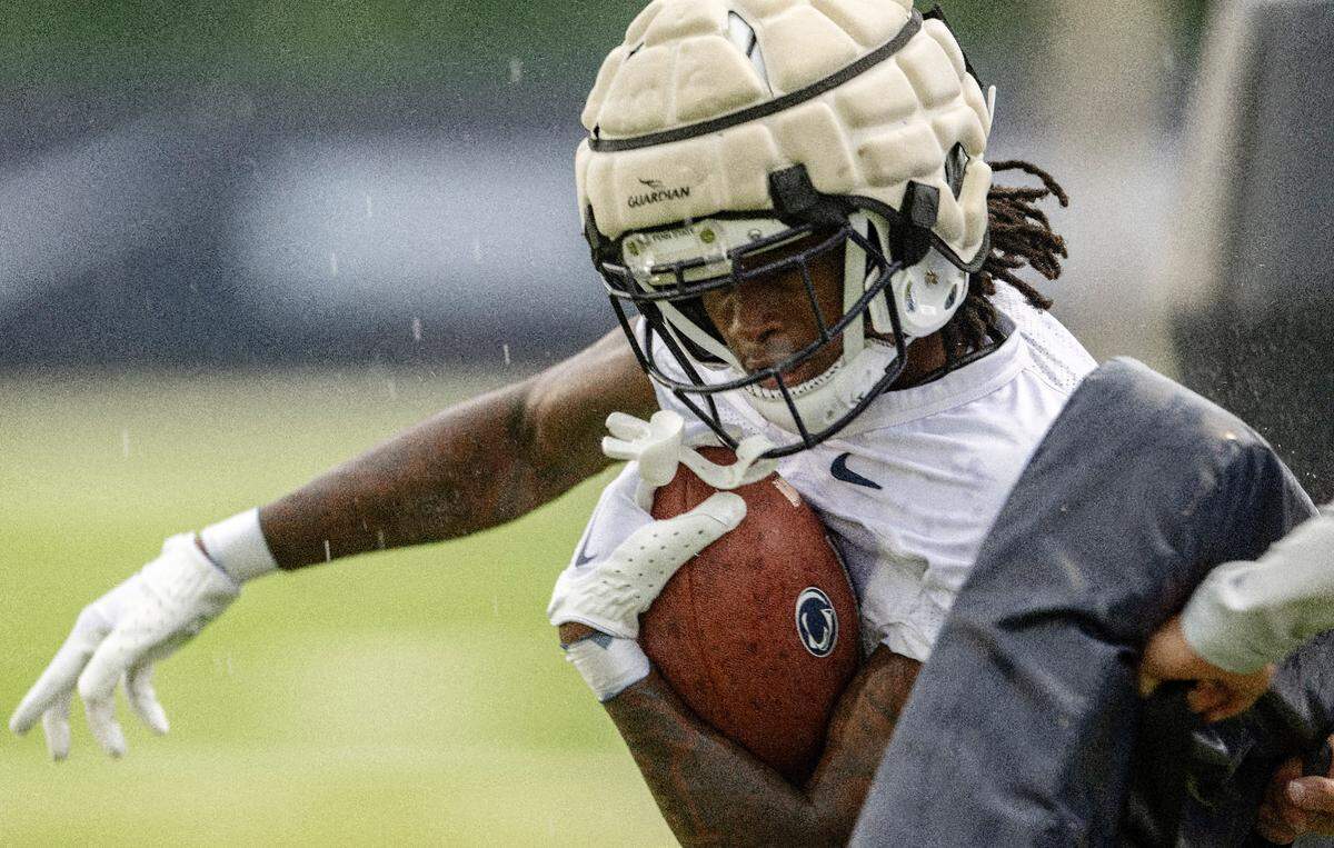 Penn State wide receiver KeAndre Lambert-Smith runs a drill as it starts to rain during practice on Sunday, Aug. 6, 2023.