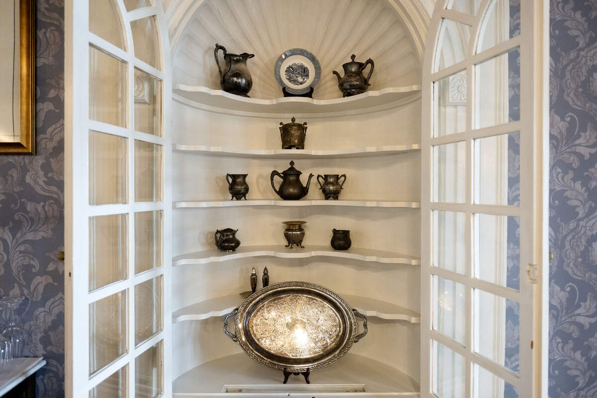 An original wooden cabinet filled with items found in the Nittany Lion Inn in the hotel’s restaurant, Lionne.