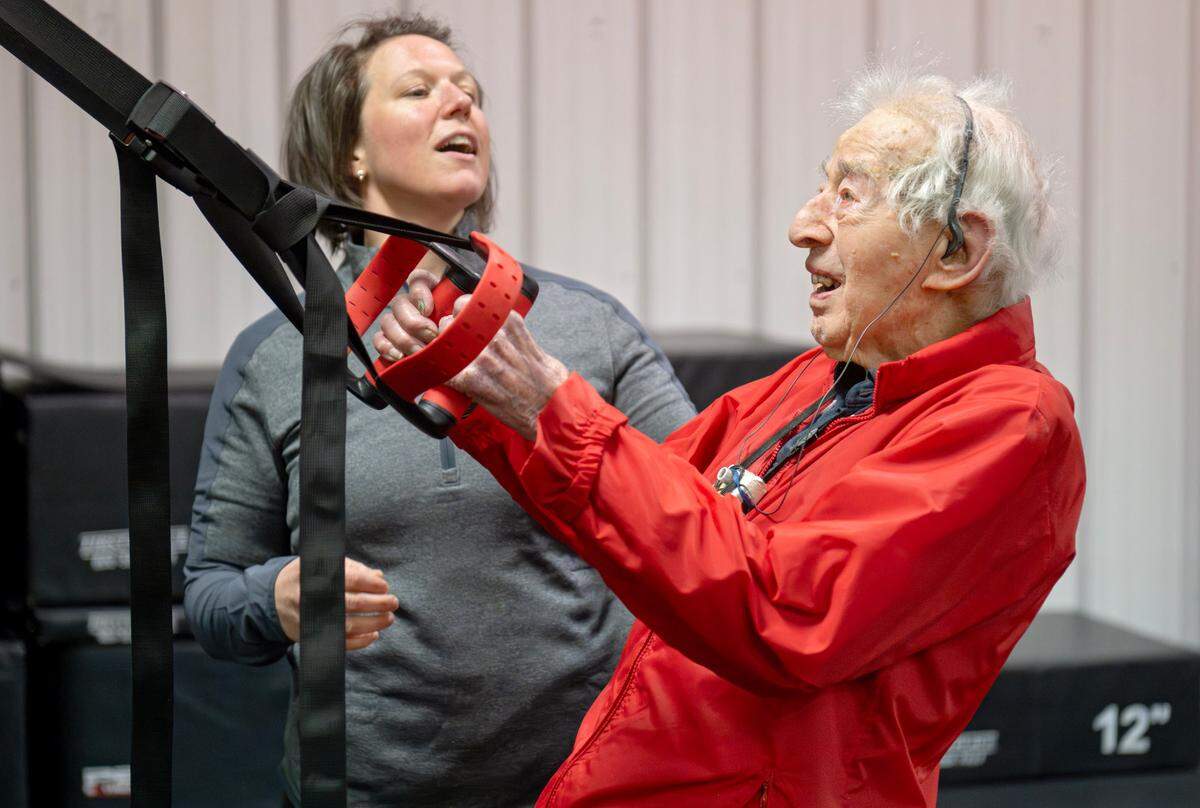 Trainer Berta DeDonato reminds George Etzweiler to keep his head up as he exercises at Ki’netik Fitness on Friday, April 5, 2024.