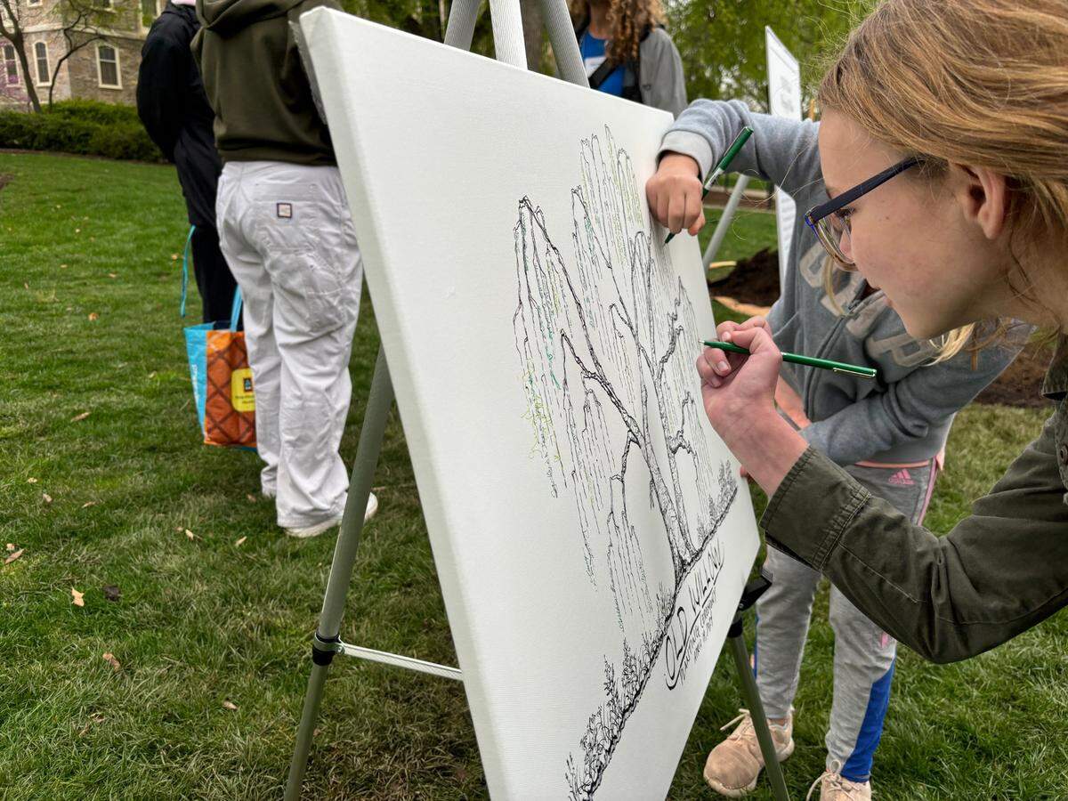 Attendees sign the drawing of the original Old Willow to commemorate the planting of the tree’s fourth generation.