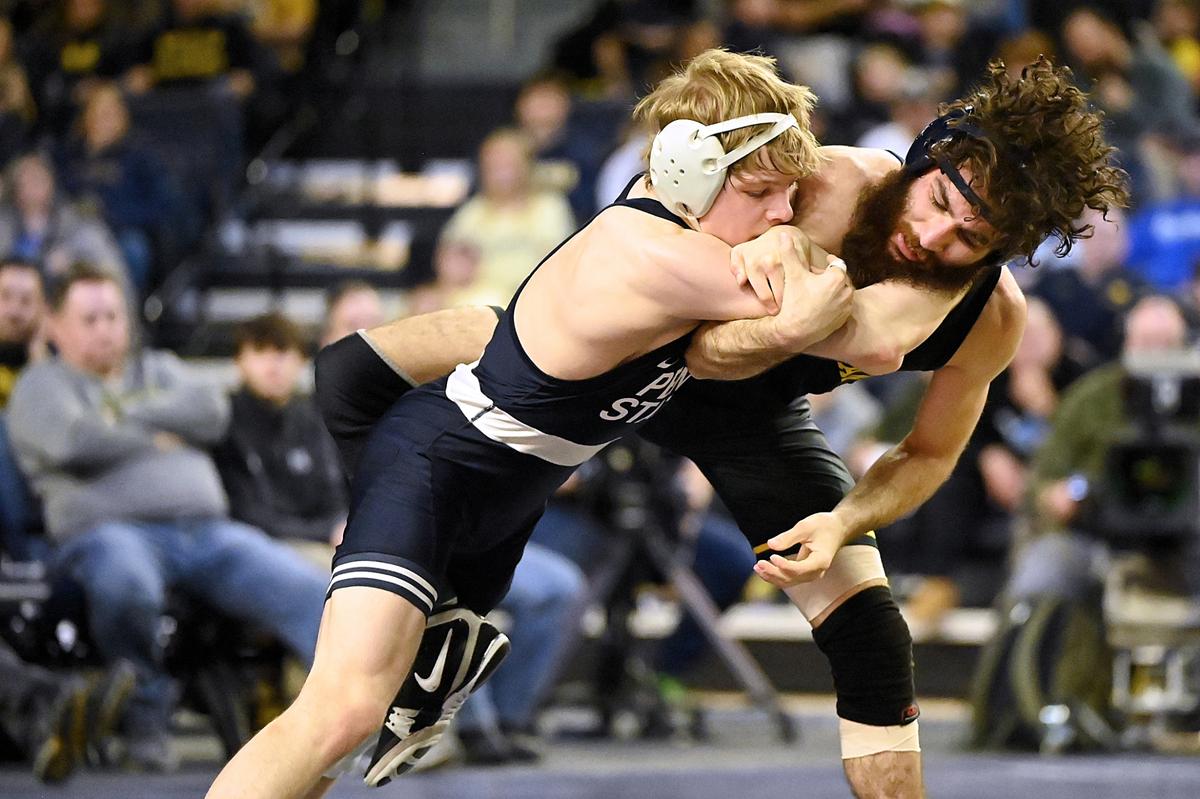 Penn State’s Braeden Davis battles with Michigan’s Michael DeAugustino in their 125 pound match of the Nittany Lions’ 27-9 win on Jan. 19 in Ann Arbor, Mich. Davis upset No. 5 DeAugustino, 5-1.