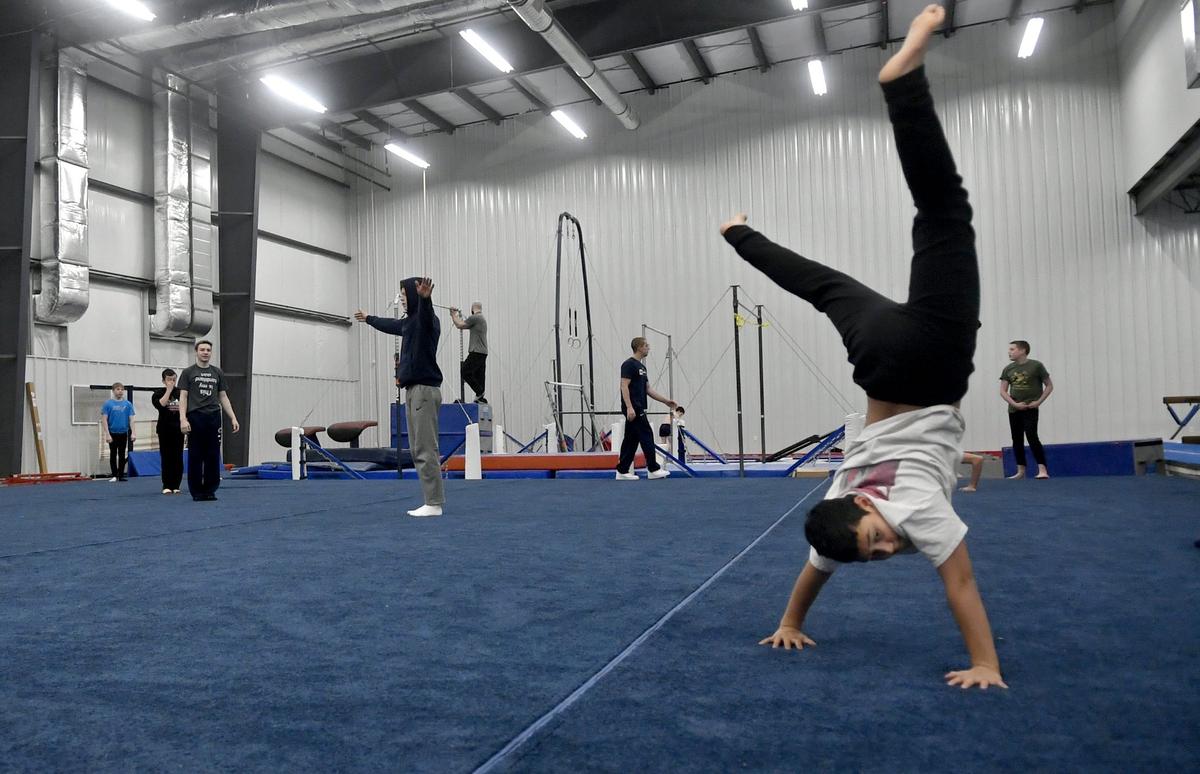 Members of Centre Elite Gymnastics warm up in the new 16,000 sq. ft. gymnastics training center at Nittany Valley Sports Centre on Wednesday, Feb. 27, 2019.