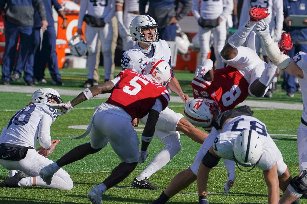 Penn State kicker Jake Pinegar (92) kicks a field goal with Penn State’s Jordan Stout (98) holding, as Nebraska’s Deontai Williams (8) and Cam Taylor-Britt (5) defend during the first half of an NCAA college football game in Lincoln, Neb., Saturday, Nov. 14, 2020.