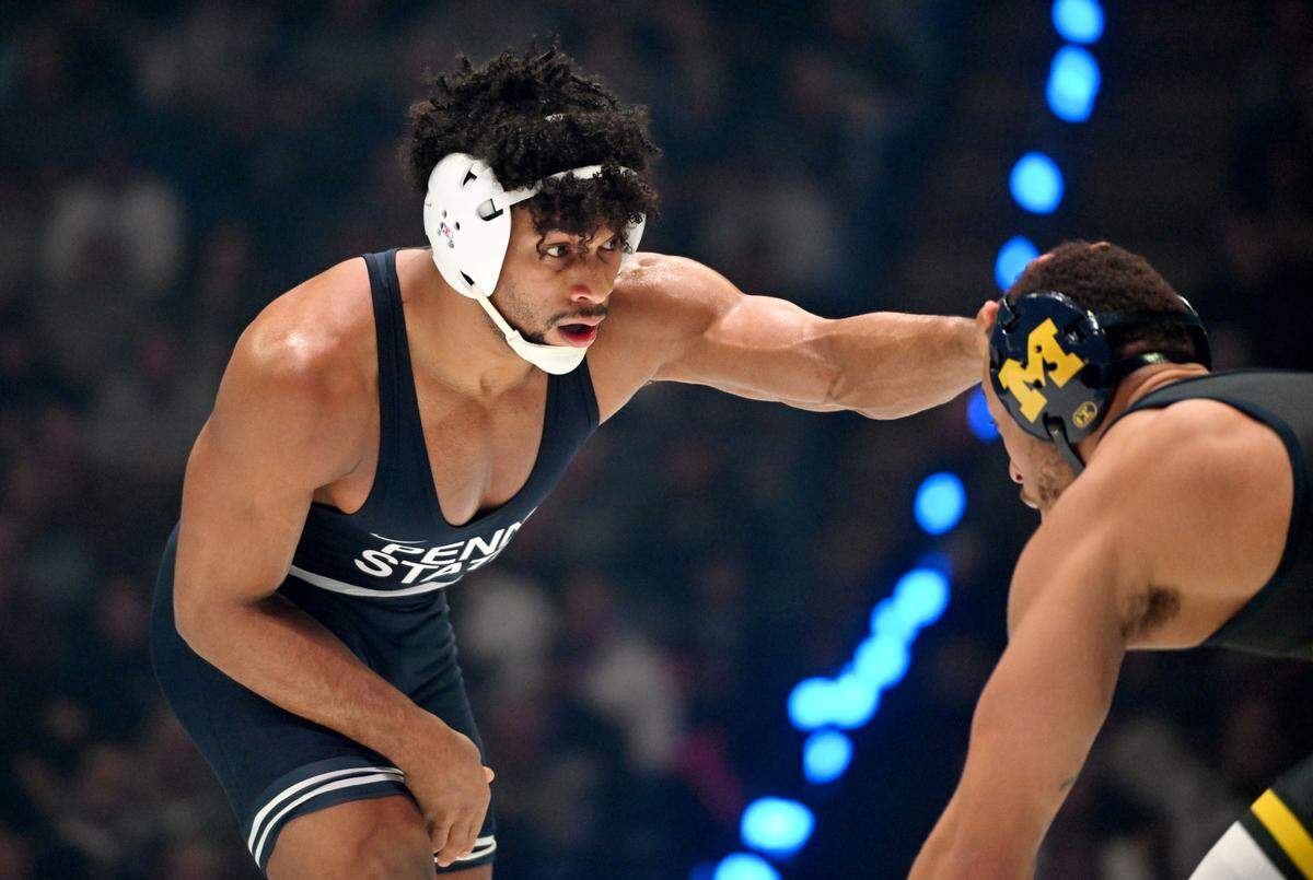 Penn State’s Carter Starocci reaches for Michigan’s Jaden Bullock in the 184 lb bout of the match on Friday, Feb. 7, 2025 in the Bryce Jordan Center. Starocci won by tech fall.