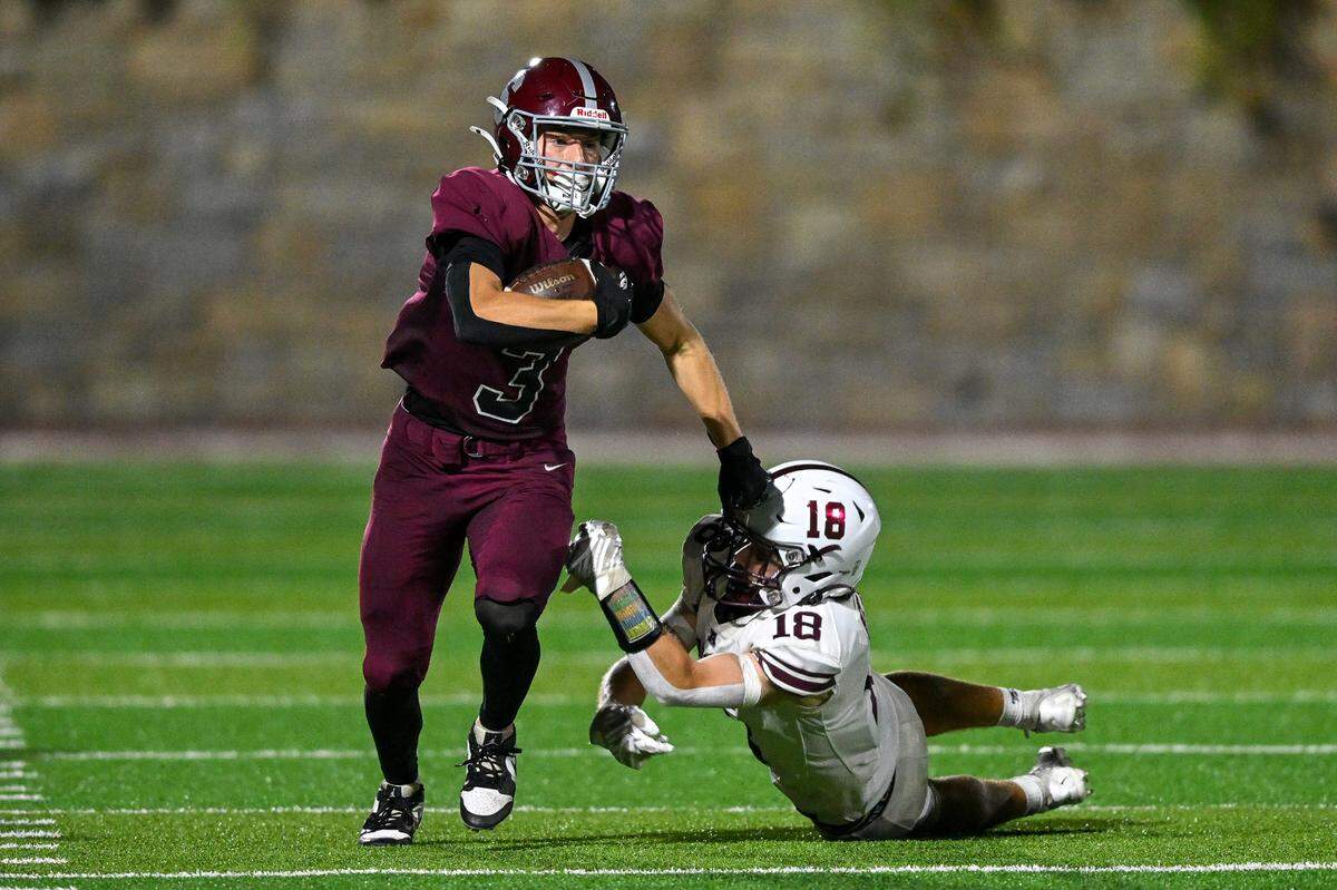 State College’s Ty Salazer breaks a tackle as he moves the ball further down field during the Little Lions’ home opener against Altoona on Friday, Aug. 30, 2024.