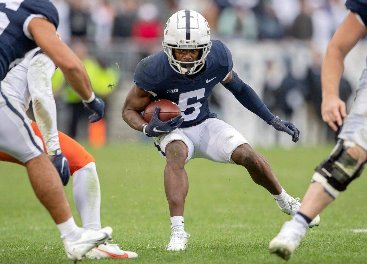 Penn State wide receiver Jahan Dotson cuts down the field with the ball from Illinois defenders during the second overtime of the game on Saturday, Oct. 23, 2021.