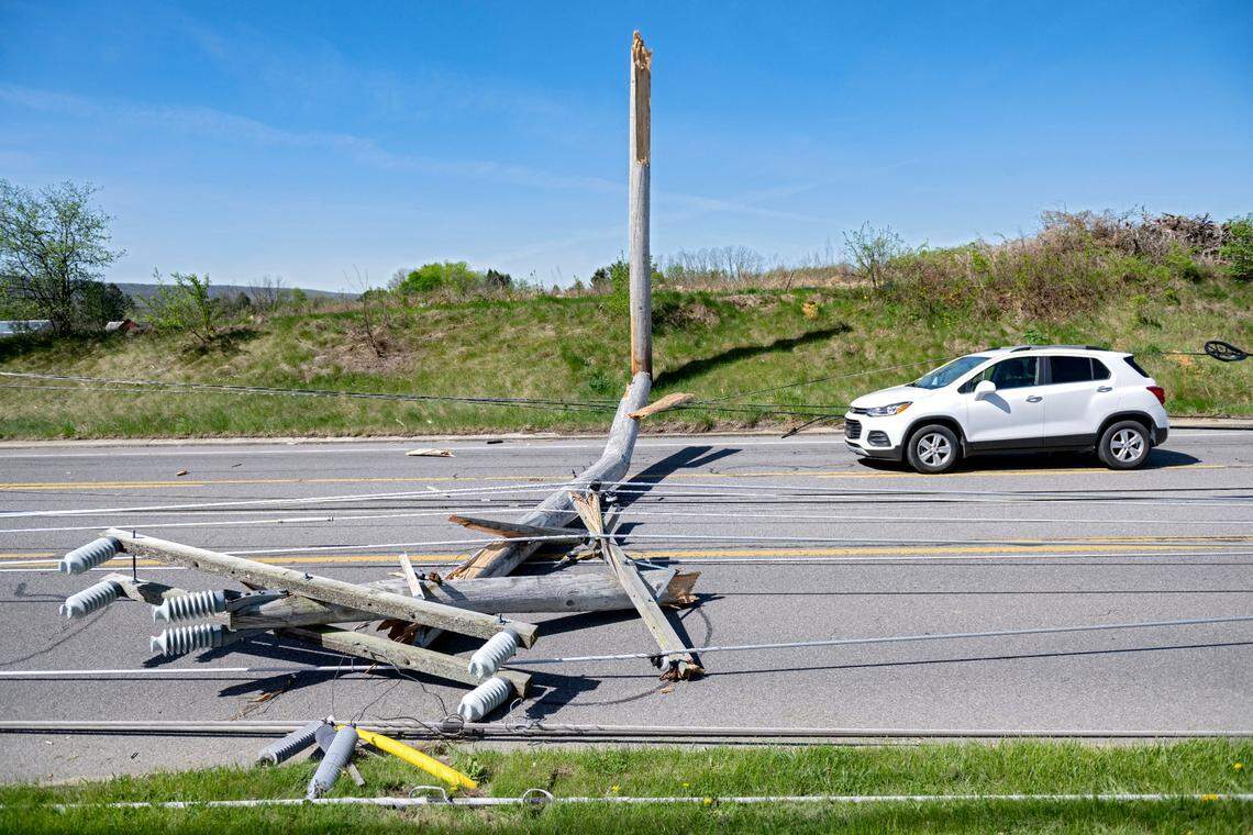 Multiple poles and wires down across cars on West College Avenue between Whitehall Road and Bristol Avenue on Wednesday, April 30, 2025 after a severe storm on Tuesday night. 
