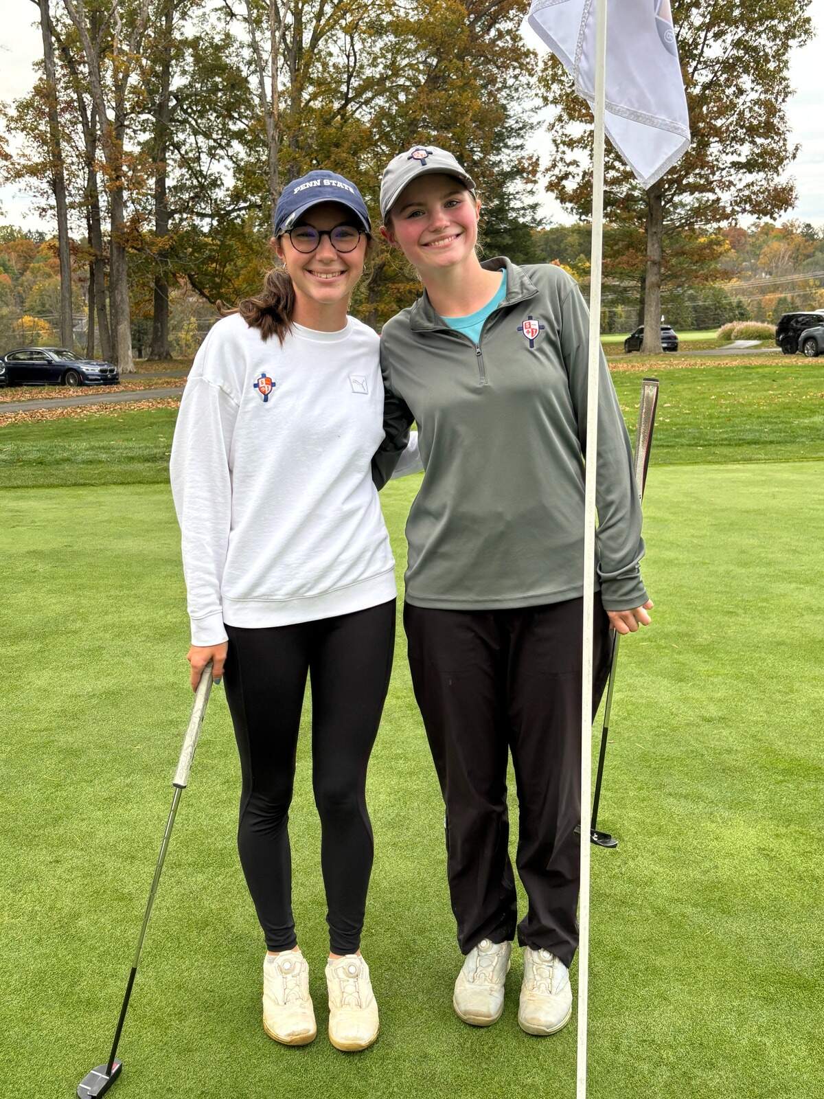 St. Joseph’s Catholic Academy senior Madison Koshko, left, poses with her sister Olivia after winning a PIAA girls golf title Tuesday at Penn State White Course. Olivia Koshko, a sophomore, also competed and finished with a fifth-place medal.