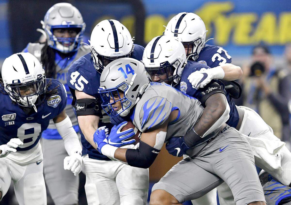 Penn State linebacker Charlie Katshir (45), linebacker Jesse Luketa (40) and safety Drew Hartlaub (37) stop Memphis wide receiver Antonio Gibson during the Cotton Bowl at AT&T Stadium in Arlington, TX on Saturday, Dec. 28, 2019.