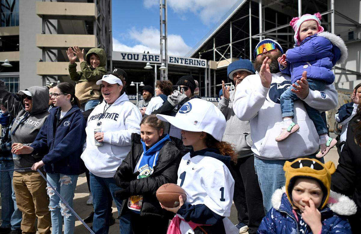 Penn State fans greet the football team to Beaver Stadium for the Blue-White game on Saturday, April 13, 2024.
