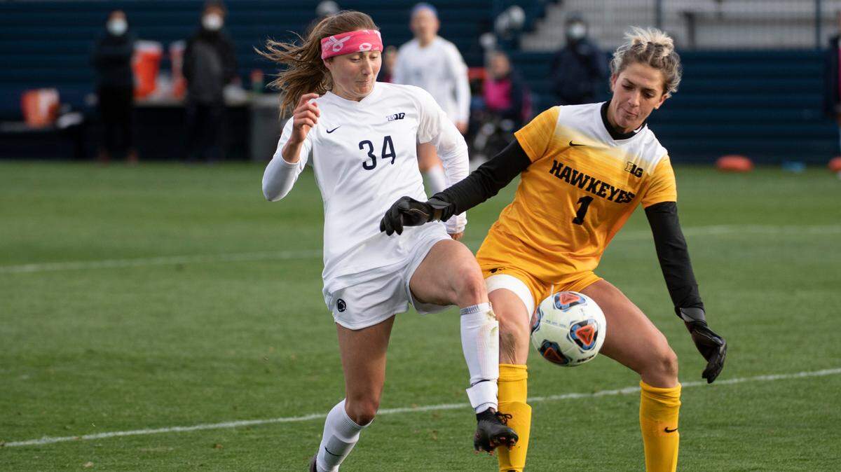 Penn State Forward Ally Schlegel (34) battles for the ball with Iowa Goalkeeper Macy Enneking (1) during an NCAA college soccer game in the semifinals of the Big Ten Conference tournament, Thursday, April 15, 2021, in State College, Pa.