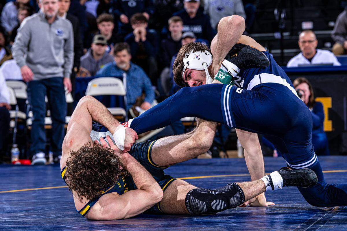 Penn State’s PJ Duke scrambles with Michigan’s Cameron Catrabone in their 157-pound bout of the Nittany Lions’ 38-3 win on Friday in Ann Arbor, Mich. Duke edged Catrabone, 12-10.